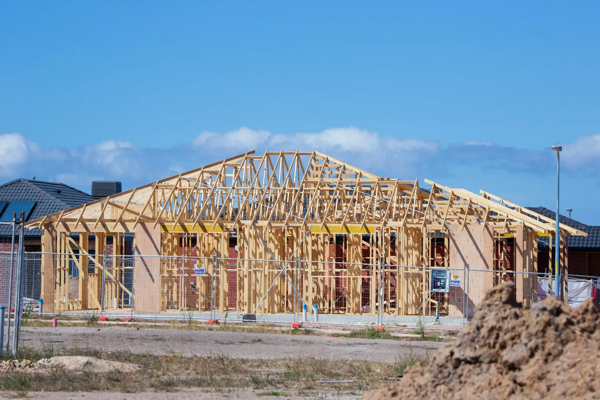Single-story house framed with trusses on a job site